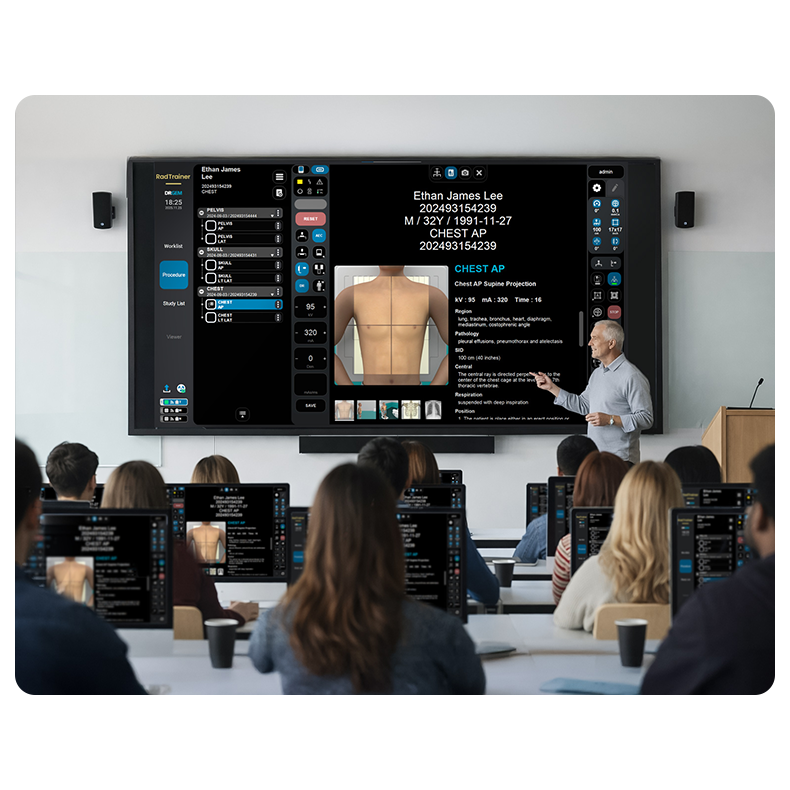 Instructor points to a medical software screen showing a patient chest diagram during a class lecture with students watching on laptops.